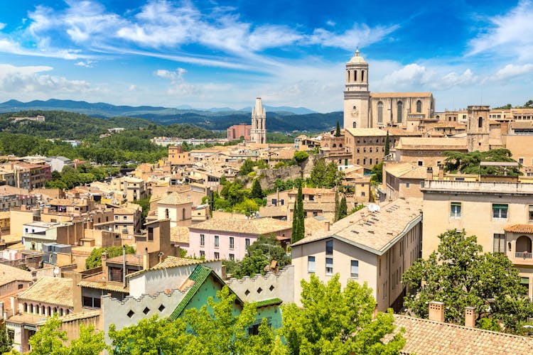 Photo of panoramic aerial view of Girona and cathedral in a beautiful summer day, Catalonia, Spain.