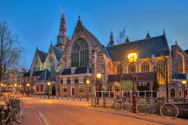 photo of the old church Oude Kerk in Amsterdam city at night, Netherlands.