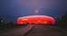 Photo of Allianz Arena, the football stadium of FC Bayern, illuminated in red at night, Germany.