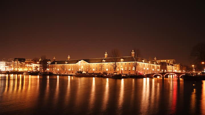 photo of "View across the Amstel River and the Hermitage Museum" - Beautiful Amsterdam by night.