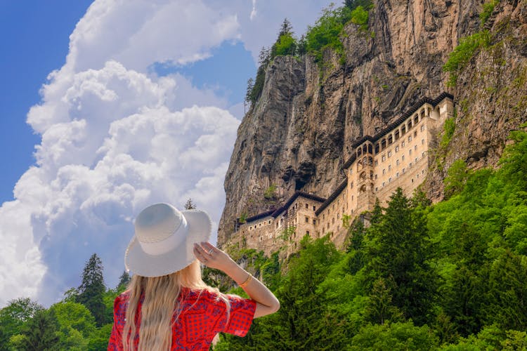 Photo of tourist woman watches Sumela Monastery in Trabzon.