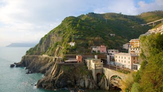 Photo of Riomaggiore with colorful houses along the coastline, one of the five famous coastal village in the Cinque Terre National Park, Liguria, Italy.