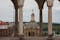 Photo of Dome of the old cathedral fo Coimbra, Portugal, among classical columns from a viewpoint at Machado de Castro National Museum.