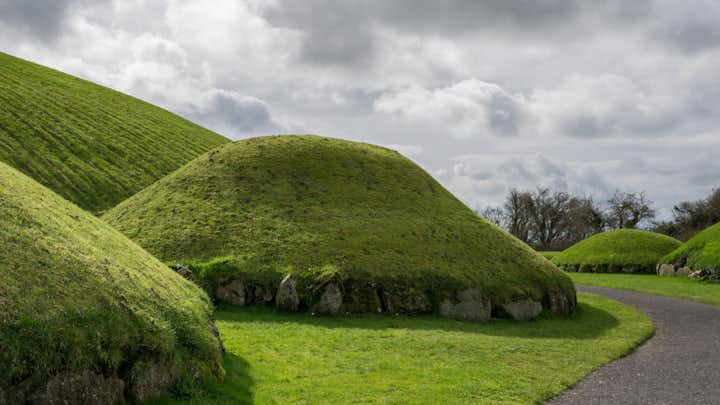 photo of Knowth, Ireland. Archaeological site in eastern Ireland. Traces of human presence from prehistoric times to the Middle Ages. Neolithic gallery tombs from the 3rd millennium BC.