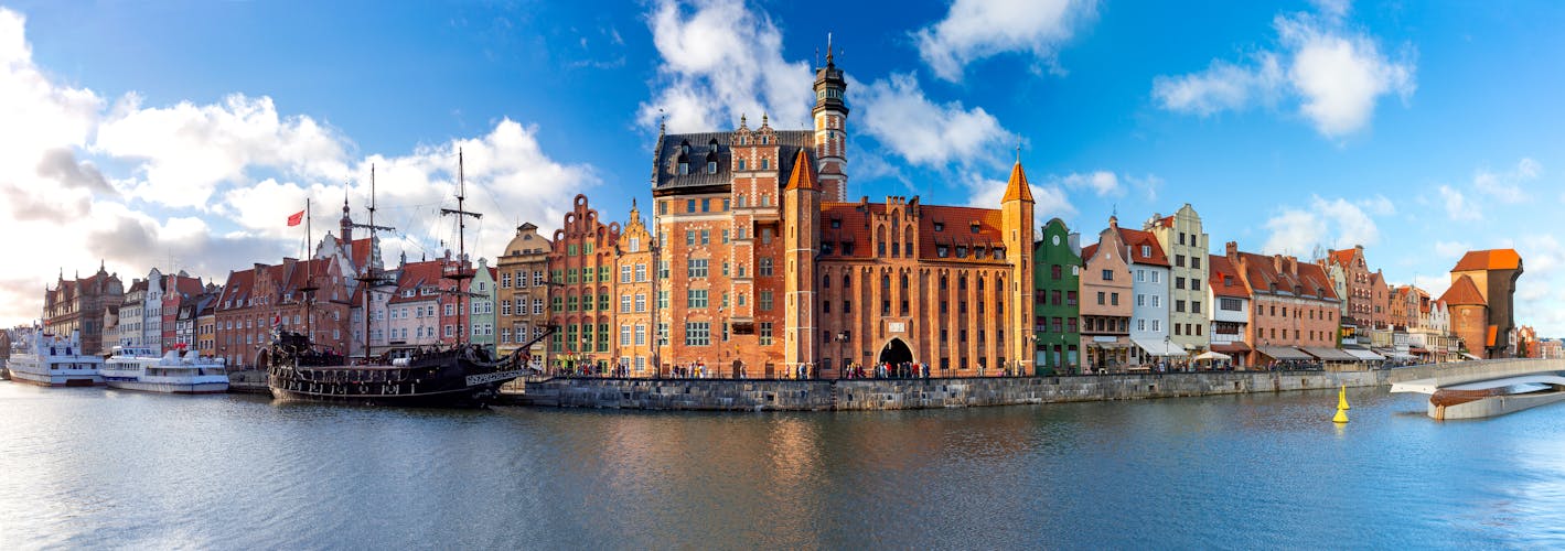 Photo of panorama of the facades of old medieval houses on the promenade in Gdansk.