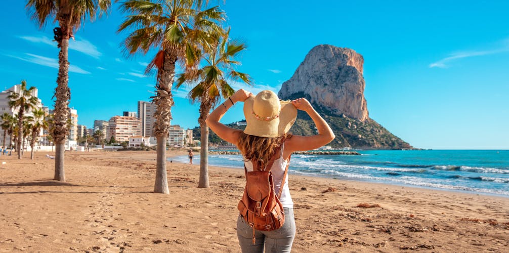 Photo of woman tourist on the tropical beach, Calpe, Alicante province in Spain.