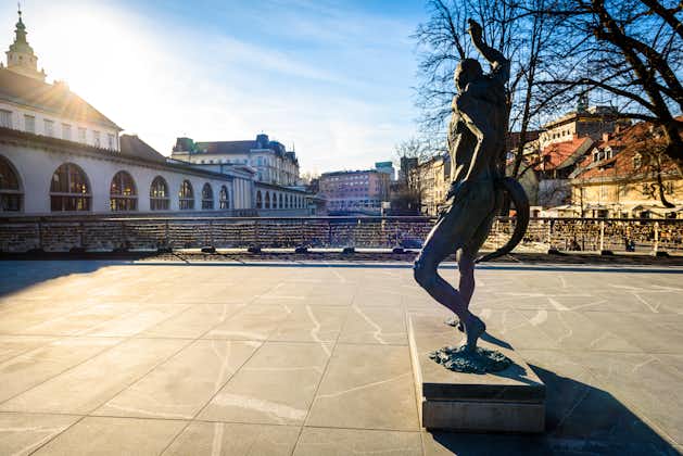 Photo of Statue of Prometheus on Butchers' bridge over river Ljubljanica. A sculpture of Prometheus by famous Slovenian sculptor Jakov Brdar on bridge with love locks in the old city centre of Ljubljana.