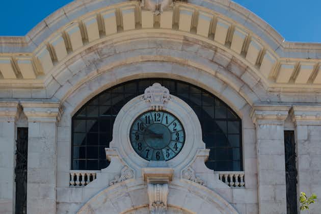 Photo of Ornate stone building with a big wall clock and an arch. Time Out Market in the centre of Lisbon, Portugal.