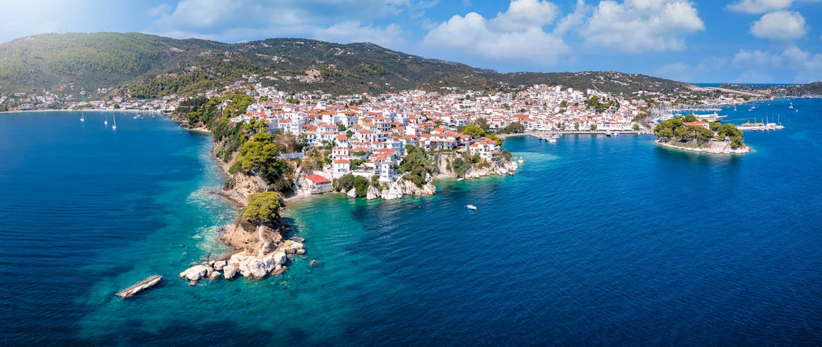 Photo of panoramic view to the harbor and town of Skiathos island.