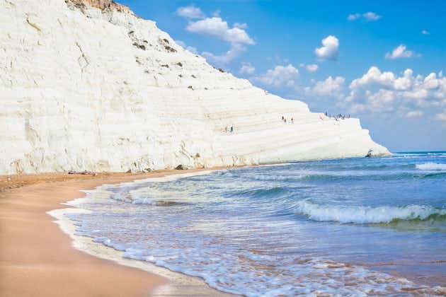 Photo of sandy beach under famed white cliff, called "Scala dei Turchi", in Sicily, near Agrigento, Italy.