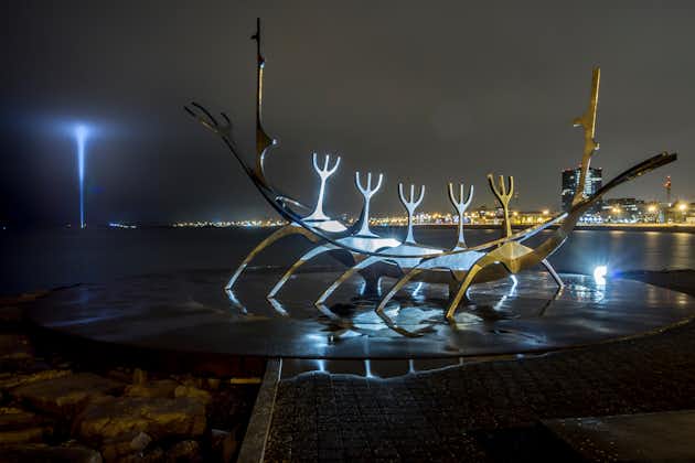 photo of Reykjavik ,Iceland 25th march 2014 : the sun voyager at night with the imagine peace tower ,which is a memorial to John lennon and his message illuminated in the distance.