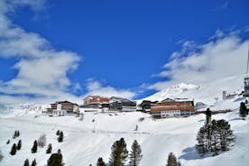 Photo of The mountain village at the Austrian ski resort Soelden on a cold and sunny winter day.