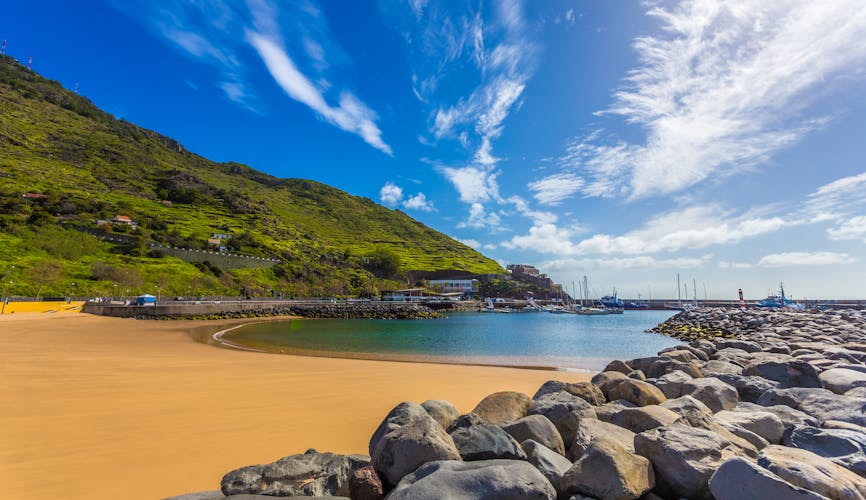 Photo of tropical Machico beautiful bay beach on the coast of Madeira island.