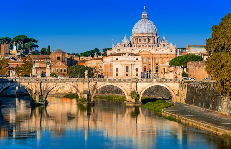  Vatican dome of San Pietro and Sant Angelo Bridge, over Tiber river in Rome, Italy.