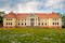 Durbe manor house near Tukums, Latvia with dandelion field in front