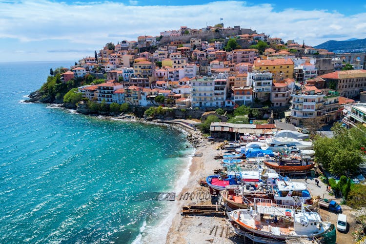 Photo of aerial view the beach of city Kavala in northern Greek, ancient aqueduct Kamares and homes in the background.