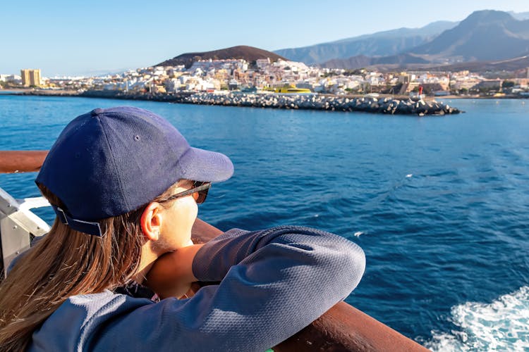 Photo of woman enjoying the panoramic view from the ferry on the port of San Sebastian de La Gomera.