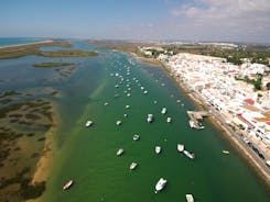 Photo of aerial view of pier fishing boats in the village Cabanas de Tavira, Portugal.