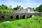 photo of view of Medieval Desmond Castle, Ireland with old stone bridge, Adare, County Limerick, Medieval Desmond Castle, Ireland with old stone bridge, Adare, County Limerick, Irland.