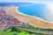 Photo of wonderful romantic afternoon aerial landscape coastline of Nazare beach riviera (Praia da Nazare) with cityscape of Nazare town ,Portugal.