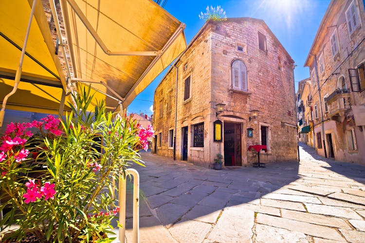 Photo of sunny stone street of ancient Pula view.