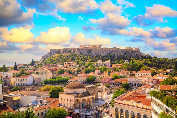 Photo of skyline of Athens with Monastiraki square and Acropolis hill during sunset.