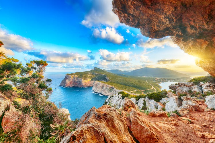 Fantastic morning view on Cacccia cape. View from the cave on the cliff, Alghero, Province of Sassari, Italy, Europe.