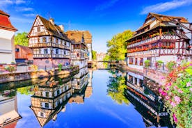 Photo of traditional half-timbered houses on picturesque canals in La Petite France in the medieval fairytale town of Strasbourg, France.