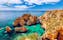 Photo of panoramic beautiful view of Ponta da Piedade with seagulls flying over rocks near Lagos in Algarve, Portugal.
