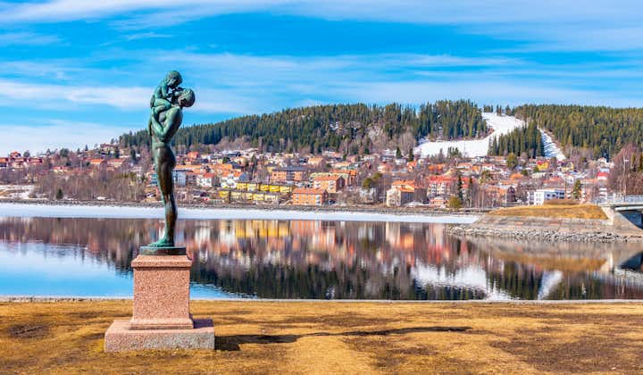 Skyline of Ostersund with a statue of father and a kid in Sweden.