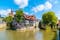 Photo of old town houses of Esslingen am Neckar city in summer with blue sky and sun next to Neckar river water, Germany.