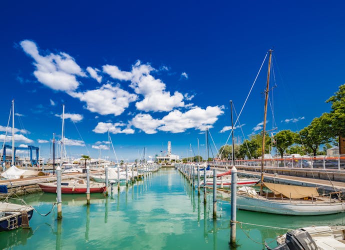 Photo of Scenic spring view of pier with ancient and modern buildings, ships, yachts and other boats in Rimini, Italy.