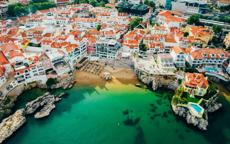 Photo of aerial view of Praia da Rainha and historic city centre of Cascais with it's beautiful beach, Portugal.