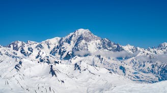 Photo of The winter view on the montains and ski lift station in French Alps near Chamonix Mont-Blanc.