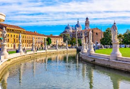 Photo of beautiful view of canal with statues on square Prato della Valle and Basilica Santa Giustina in Padova (Padua), Veneto, Italy.
