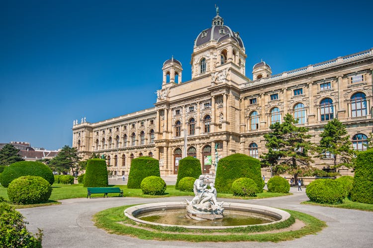Photo of beautiful view of famous Naturhistorisches Museum (Natural History Museum) with park and sculpture in Vienna.