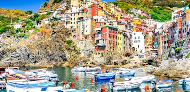 Photo of Riomaggiore with colorful houses along the coastline, one of the five famous coastal village in the Cinque Terre National Park, Liguria, Italy.