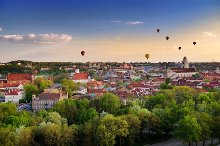 Photo of beautiful summer panorama of Vilnius old town with colorful hot air balloons in the sky