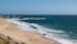 Beautiful sandy beach of Vila do Conde, Portugal with bright blue sky and turquoise sea on a sunny day in summer