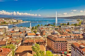 Geneva skyline cityscape, French-Swiss in Switzerland. Aerial view of Jet d'eau fountain, Lake Leman, bay and harbor from the bell tower of Saint-Pierre Cathedral. Sunny day blue sky.