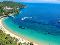 Photo of beautiful aerial view of the old town Skiathos with boats in the harbor, on Skiathos Island, Greece. 