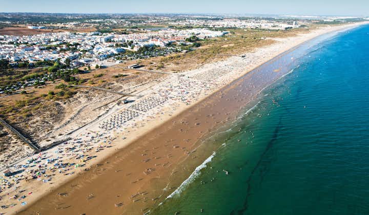 Aerial view of Manta Rota beach, part of a long sweep of fine sand that arches from the frontier town of Vila Real de Santo Antonio on the Spanish border to Praia de Cabanas in Tavira in Portugal.
