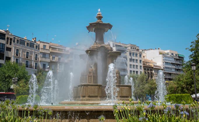 photo of the monumental fountain of battles during a sunny summer day in the city of Granada, Spain.