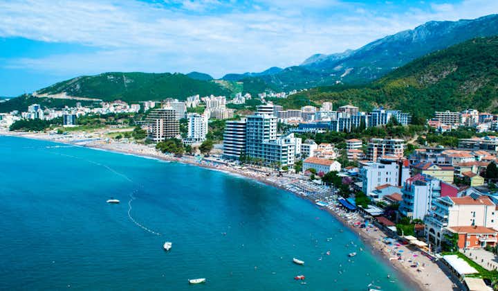 Photo of panoramic aerial view of the beach and the resort towns of Becici and Rafailovici, at the foot of the mountains, Montenegro.