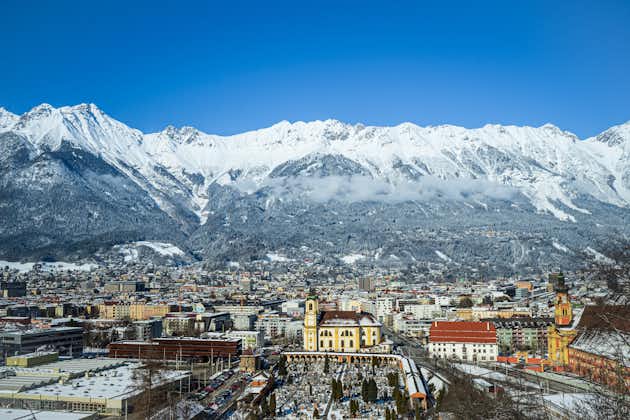 photo of cityscape of the alpine city Innsbruck in Austria, framed by the Nordkette.
