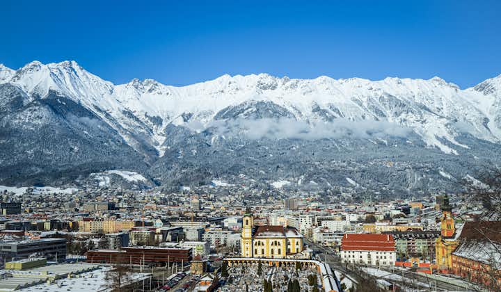 photo of cityscape of the alpine city Innsbruck in Austria, framed by the Nordkette.