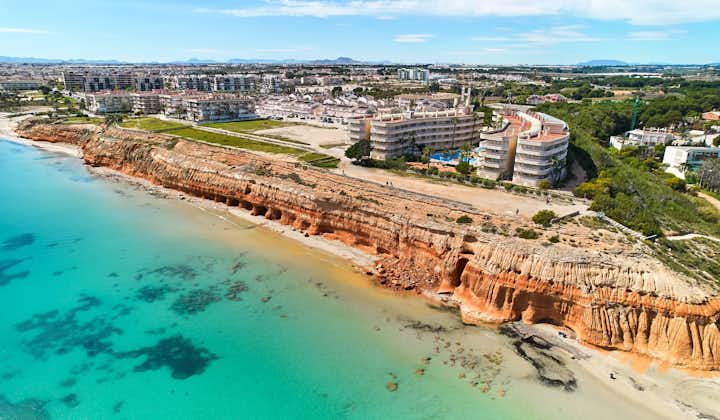 Photo of aerial view of Dehesa de Campoamor townscape with sandy beach, Province of Alicante, Spain.