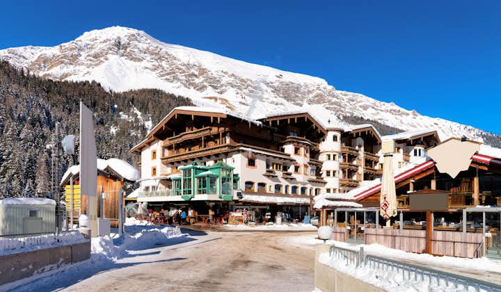 Photo of street view with wooden chalet houses at Hintertux Glacier in Tyrol in Mayrhofen in Austria, winter Alps.