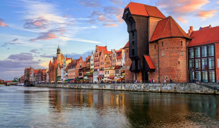 Photo of the Zuraw Crane and colorful gothic facades of the old town in Gdansk.