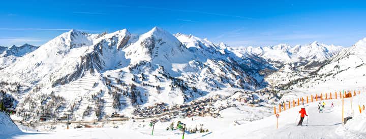 photo of Obertauern, Salzburg area, Austria - Ski resort, hut, skiers and slope in Austrian Alps.